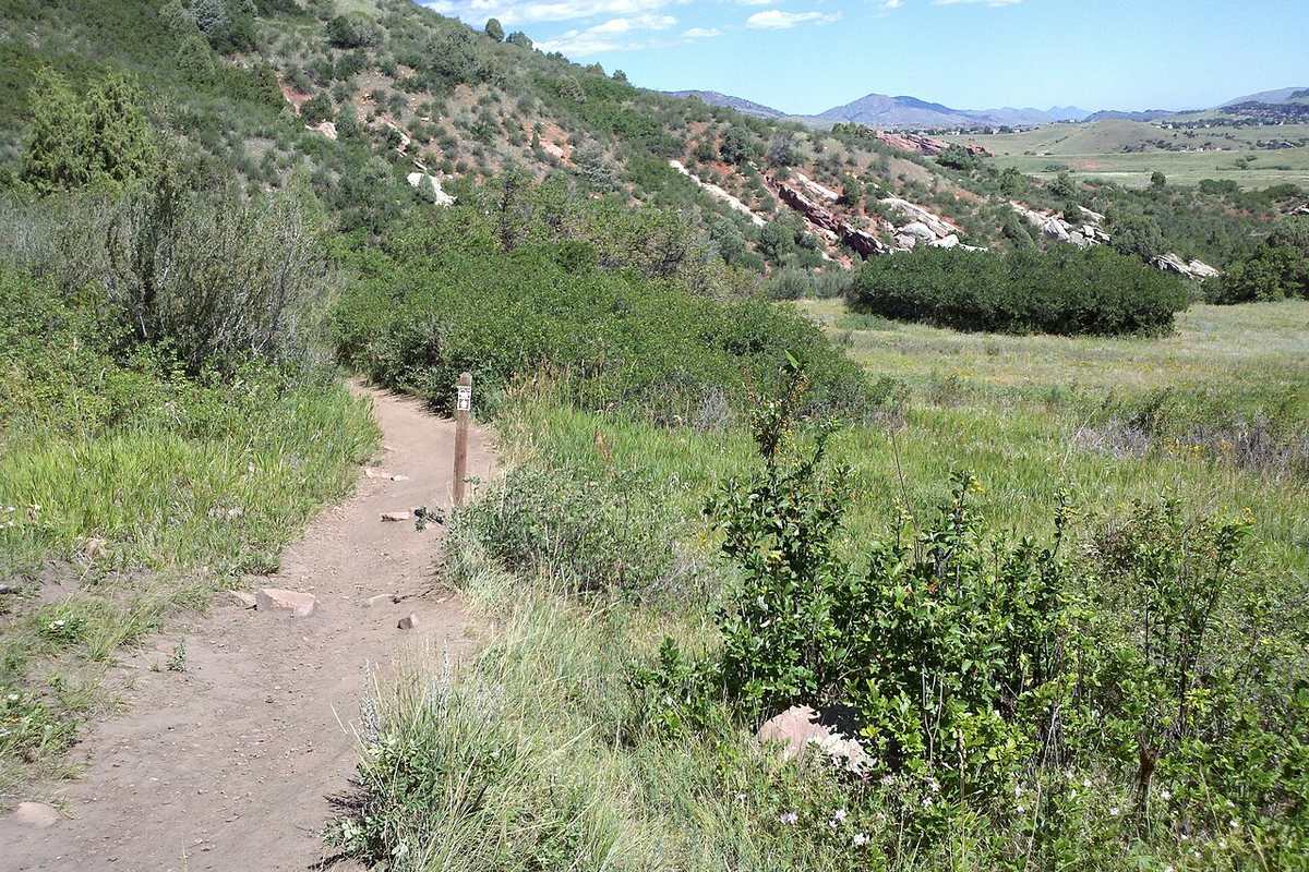 Trail through meadows and red rock formations at Deer Creek Canyon Park near White Deer Valley Littleton